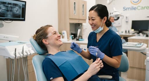 Patient smiling happily during dental care examination